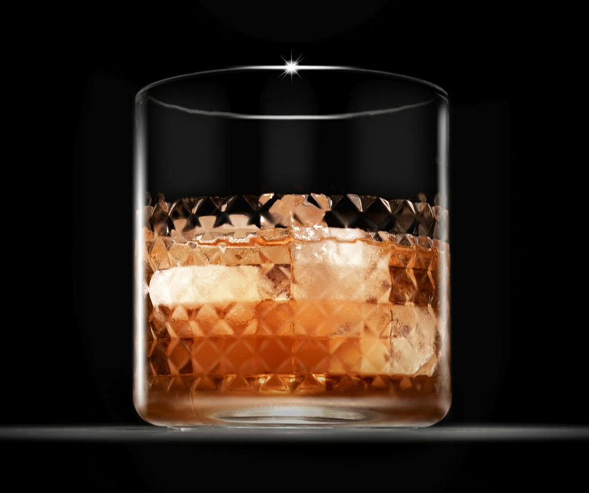 A crystal rocks glass of bourbon over ice